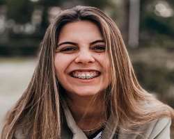 She used braces to correct her teeth.